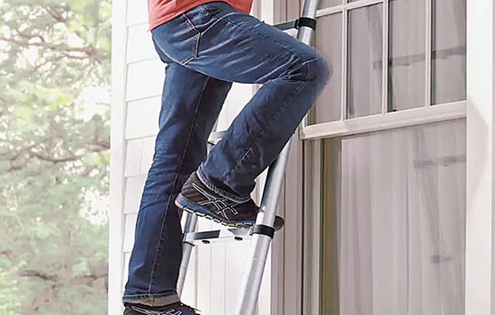 man standing firmly on the telescopic extension ladder